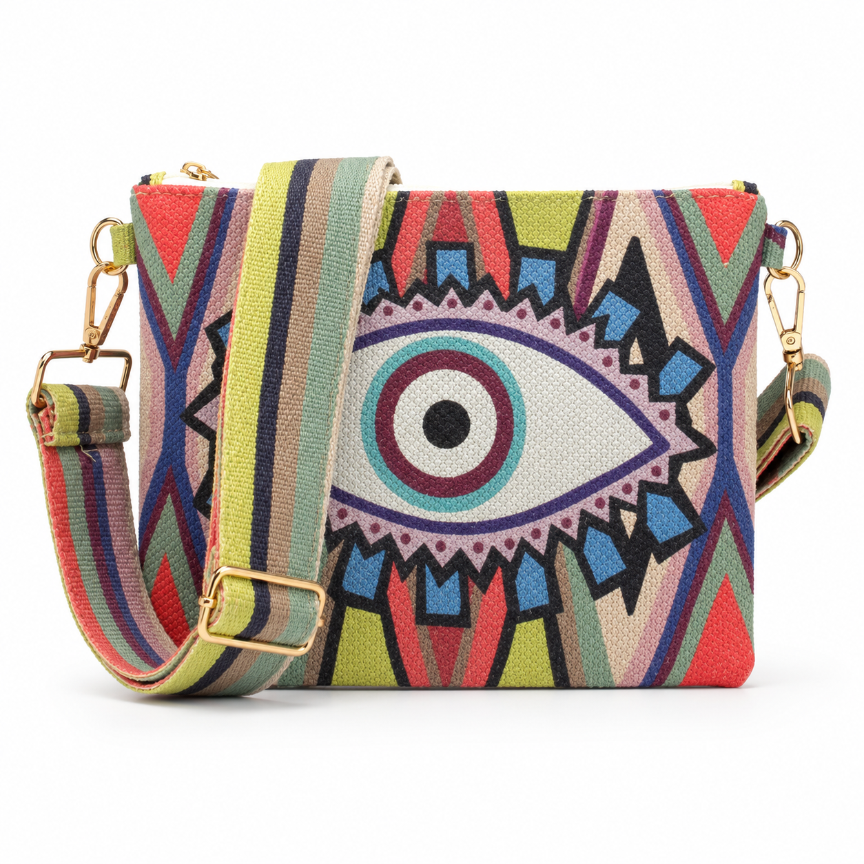 A rectangular crossbody bag featuring a vibrant, multicolored geometric pattern with a large central stylized eye motif. The bag has a matching striped fabric shoulder strap with gold-tone metal hardware, shown against a plain white background.